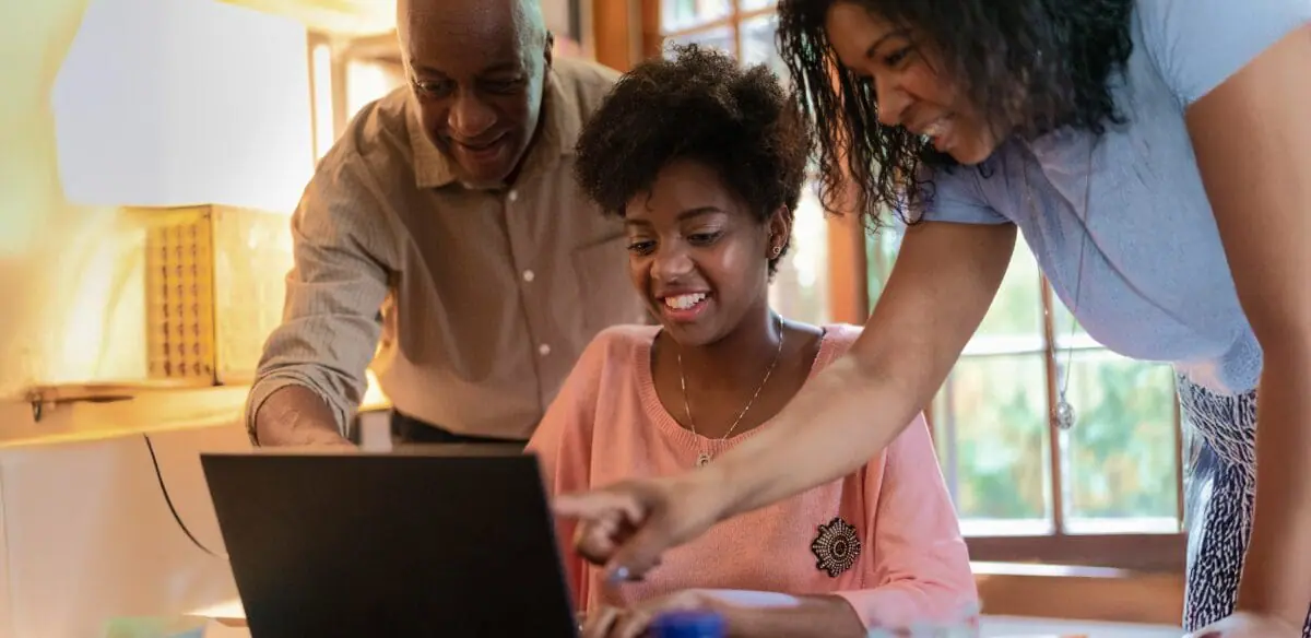 A family working together with their laptop at home